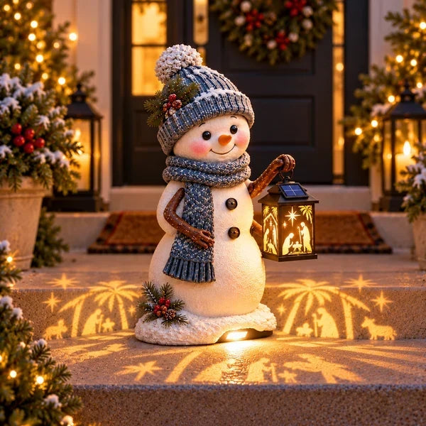 Snowman Nativity Glow beside Christmas front steps